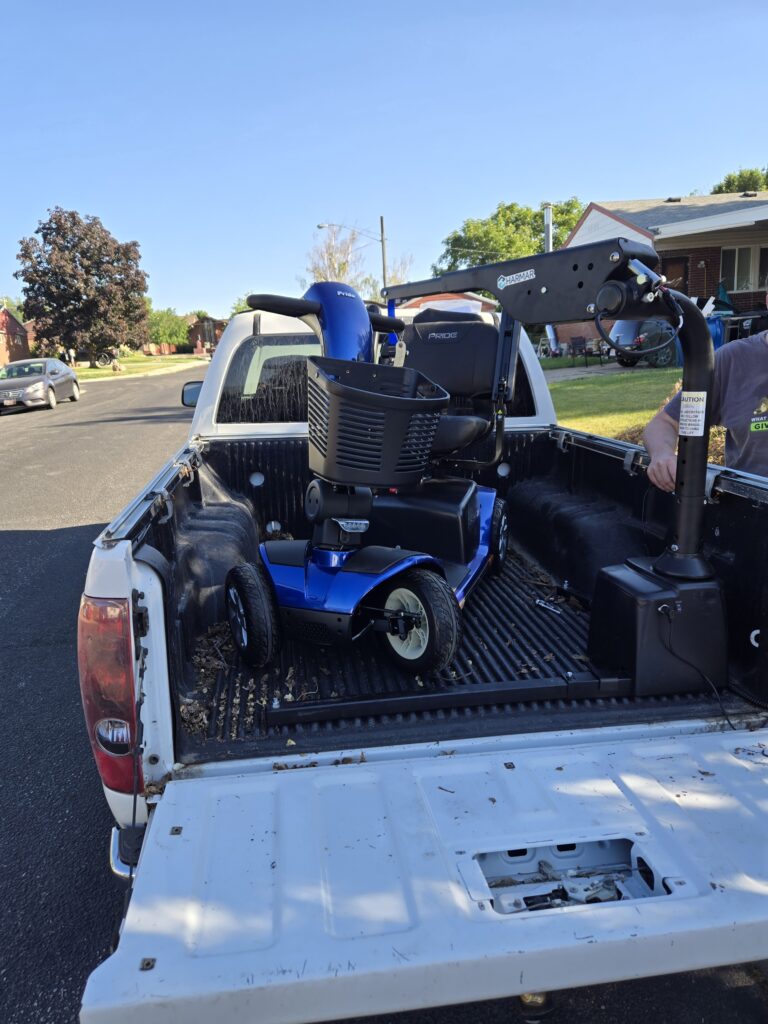 Vehicle wheelchair scooter hoist installed in truck bed by Olympus Stair Lifts