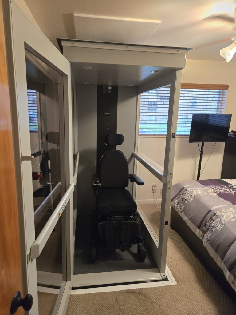 Wheelchair inside residential home elevator cab installed by Olympus Stair Lifts