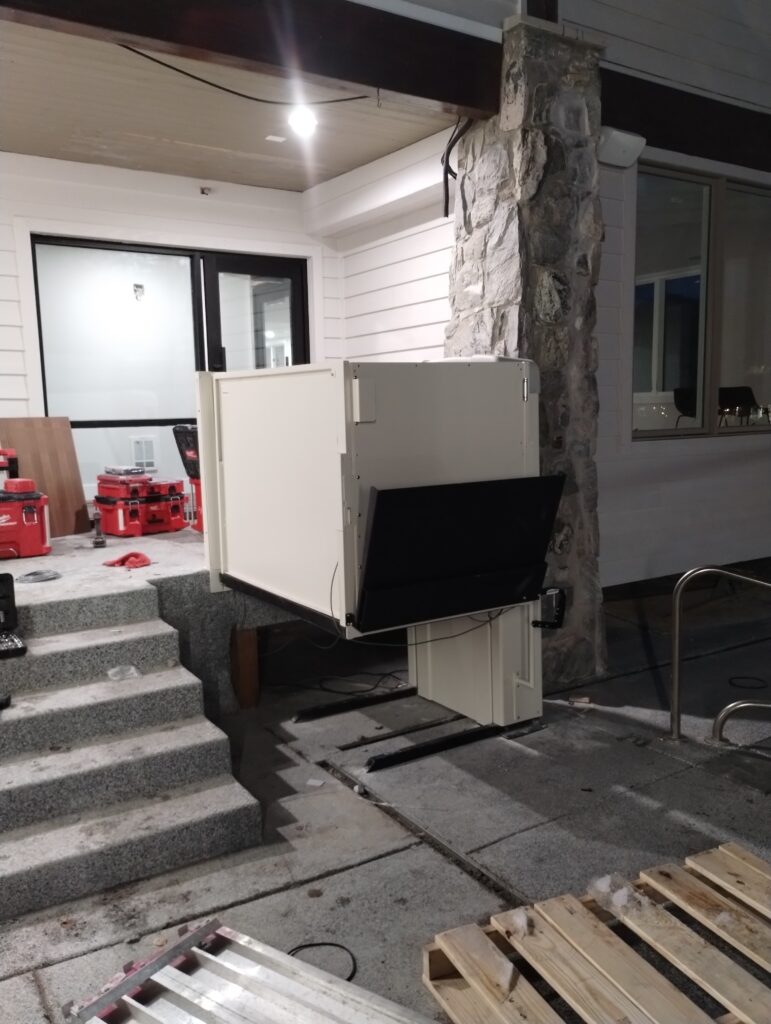 Outdoor vertical platform lift (VPL) installed on entry stairs by Olympus Stair Lifts